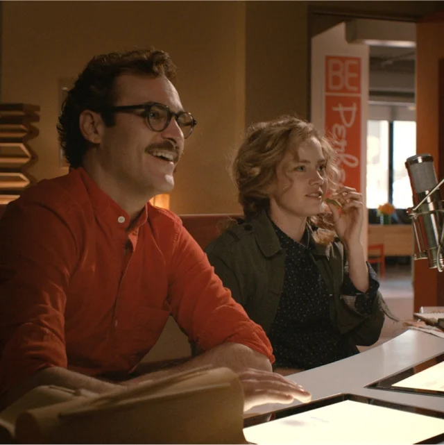 Young couple sitting and smiling, a scene from the movie &ldquo;Her&rdquo; from 2013
